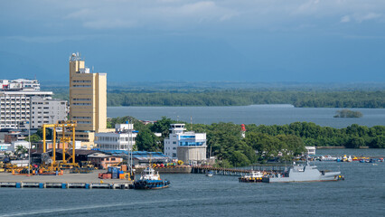 Columbian coast navy ship  alongside in port Buenaventura and city buildings and port authority...