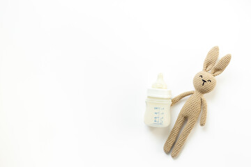Kids flat lay with baby toy and milk in bottle, top view
