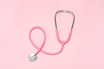 One stethoscope on pink background, top view. Medical tool