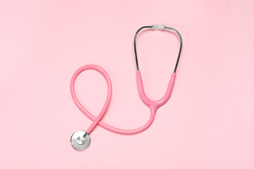 Fototapeta premium One stethoscope on pink background, top view. Medical tool
