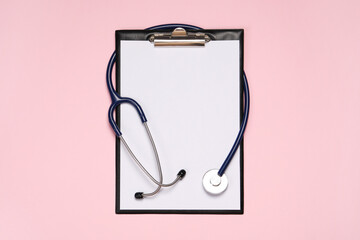 Stethoscope and clipboard on pink background, top view. Medical tool