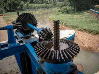 a simple mechanism for using iron gears to control water flow for irrigation
