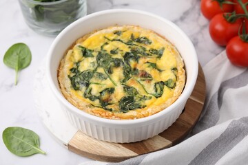 Delicious pie with spinach on white marble table, closeup