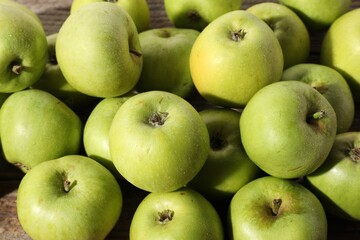 Many fresh apples on wooden table, above view