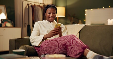 Black girl, happy and smartphone on sofa in home scrolling or online social media memes, videos and...