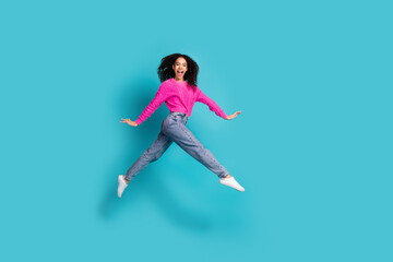 Full length photo of lovely teen lady running jump dressed stylish pink garment isolated on cyan color background
