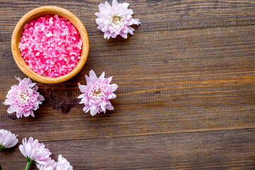 pink spa salt for aroma therapy with flower fragrance on wooden background top view copyspace