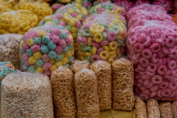 street hawking of fruity puff cereal, salted popsicle stick, crackers, puffed corn, tutuca in single bags, in Salta, Argentina