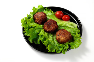 Fried cutlets on a lettuce leaf with tomatoes isolated on white background