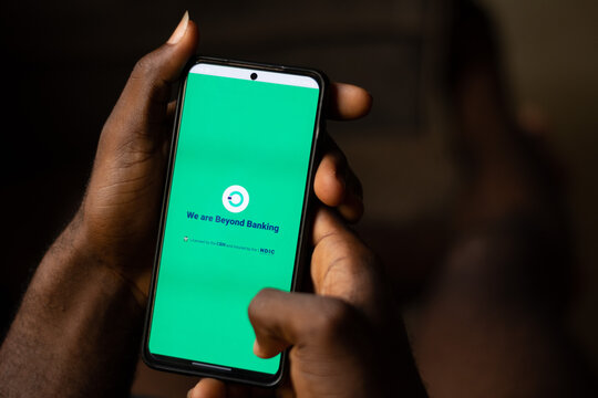 Lugbe, Abuja-Nigeria - April 22nd 2024: african person using opay mobile app