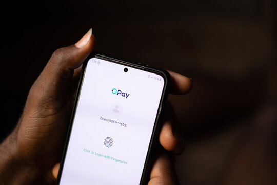 Lugbe, Abuja-Nigeria - April 22nd 2024: african person using opay mobile app