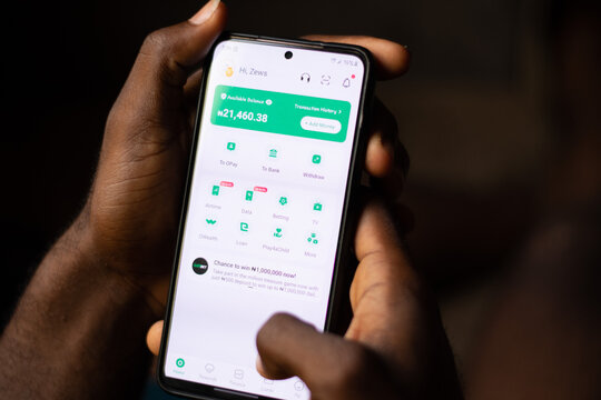 Lugbe, Abuja-Nigeria - April 22nd 2024: african person using opay mobile app