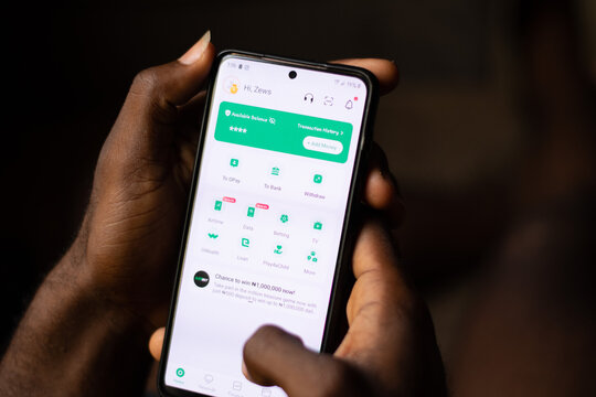 Lugbe, Abuja-Nigeria - April 22nd 2024: african person using opay mobile app
