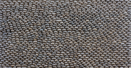 Natural Gray Cobblestone Pavement Texture Background with Smooth River Rocks Pattern