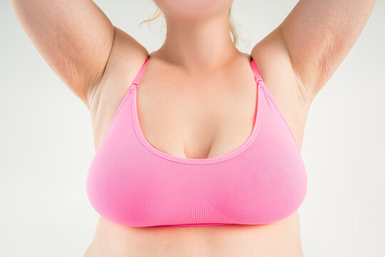 Large natural saggy breasts with asymmetry after breastfeeding, big boobs with stretch, marks, augmentation and plastic surgery concept