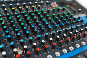 Professional audio mixing console with faders and adjusting knobs, TV equipment at party