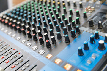 Fototapeta premium Professional audio mixing console with faders and adjusting knobs, TV equipment at party