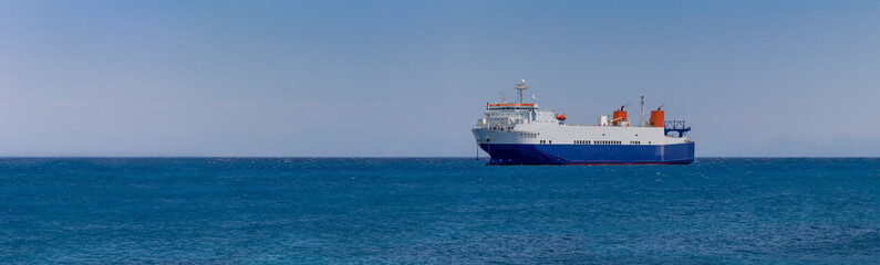 cargo ship in the middle of the sea, panorama,  banner