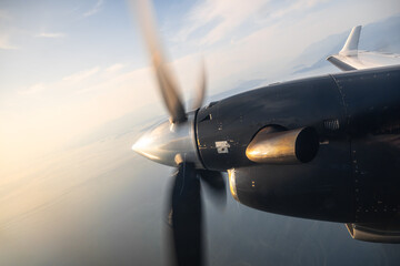 Aircraft propeller in motion flying over scenic landscape