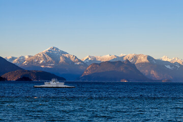 ferry boat or ship on Howe Sound with snow-capped mountains in the background