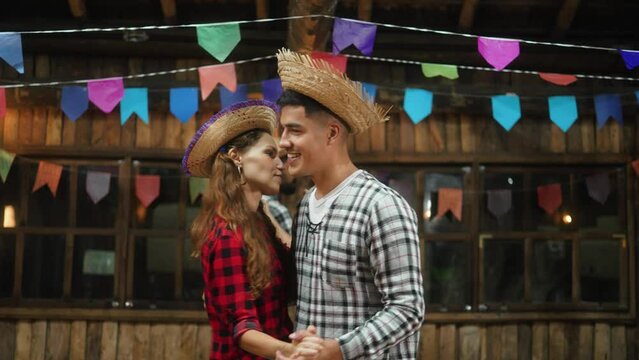 Contented Pair Swapping Partners in Enchanting Dance at Junina Celebration. Man and Woman in Festive Attire Beaming with Delight at Traditional Brazilian Festival
