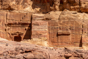 Ancient Nabatean Tombs in Petra, Jordan: Contrasting Finished and Unfinished Carvings in Majestic Sandstone Cliffs