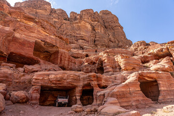 Bedouin Pickup Truck Parked in Ancient Tomb in Petra, Jordan: Modernity Meets History in Stunning Sandstone Cliffs