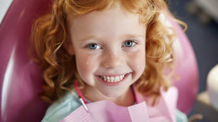 Fototapeta premium A cheerful redheaded child with freckles sits in a dental chair, smiling brightly during an afternoon dental checkup, wearing a protective bib
