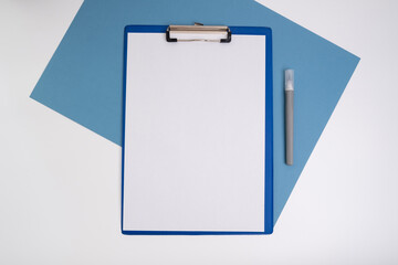 Blank tablet with a white sheet and a pen on a light background. A4 holder. Stationery. Blank document holder with space for text. Mockup