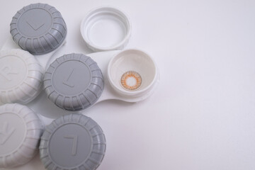 Container for lenses and accessories on a light background. Health and medicine concept