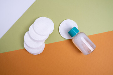 Bamboo cotton swabs, cotton pads and facial toner on a colored background. Biodegradable earplugs....