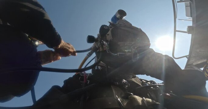 Diver undergoes post-dive teardown procedure closeup