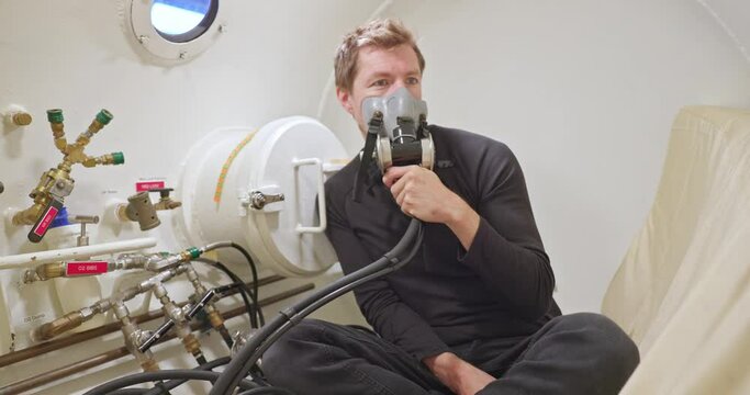 Military man in hyperbaric chamber using BIBS mask