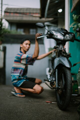A motorcycle mechanic inspecting a damaged engine