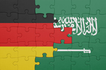 Fototapeta premium puzzle with the colourful national flag of saudi arabia and flag of germany.
