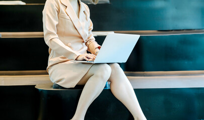 Businesswoman sitting at desk working on laptop computer Ambitious corporate manager plans...