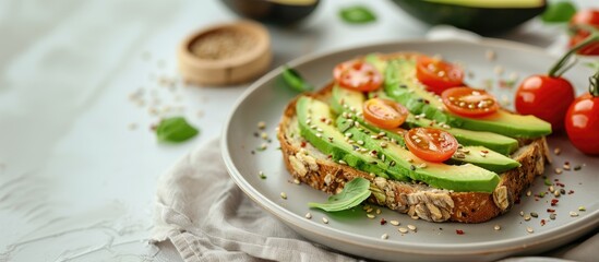 A beautifully arranged avocado toast on a ceramic plate, garnished with cherry tomatoes and seeds.