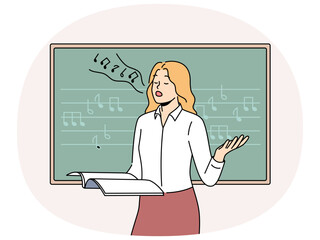 Woman vocalist sings standing near blackboard with notes and helping students develop voice. Girl holds magazine and sings wanting to become professional vocalist or audio composer