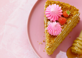 honey cake dessert on a plate on a pink background