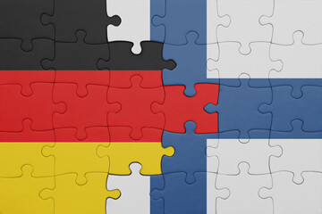 puzzle with the colourful national flag of finland and flag of germany.