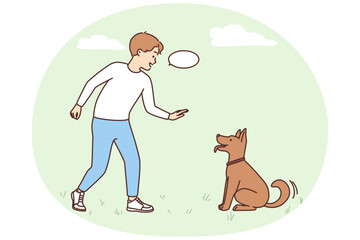 Smiling boy play with dog outdoors