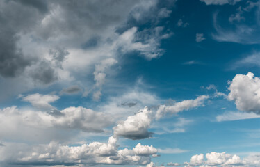 Clear blue sunny sky background with white clouds.