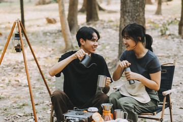 Asian couple sweet in tent inside on they camping trip, traveller relax and sleep togather in out...