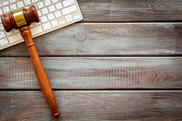 Wooden judge gavel and keyboard, top view. Lawyer desktop
