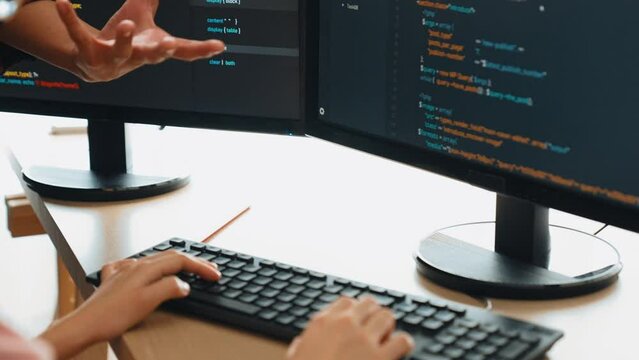 Slow motion back end or software developer manager supervising his team on new application program development on debugging and solving complex code algorithms on monitor. Burgeoning