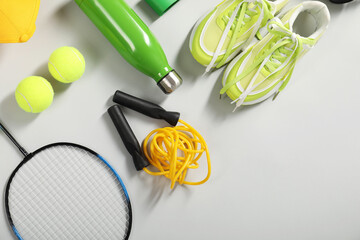 Different sports equipment on light grey background, flat lay. Space for text