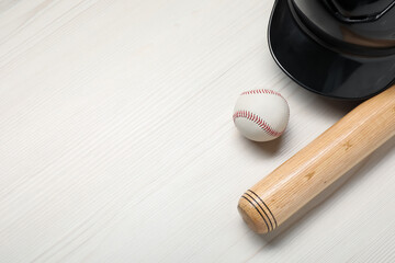 Sports equipment. Helmet, ball and baseball bat on white wooden table, flat lay. Space for text