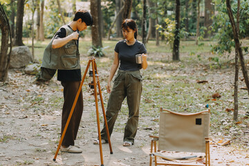 Asian couple sweet in tent inside on they camping trip, traveller relax and sleep togather in out...