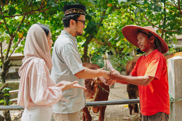 Indonesian cattleman feeling relieved after closing deal from Asian Muslim couple buying livestock...