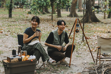 Asian couple sweet in tent inside on they camping trip, traveller relax and sleep togather in out door and camping trip